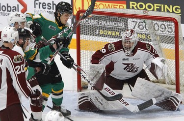 Peterborough Petes' goalie Hunter Jones blocks a shot deflected by London Knights' Jonathan Gruden during first period OHL action on Thursday December 5, 2019 at the Memorial Centre in Peterborough, Ont.