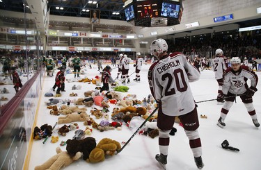 Peterborough Petes' Declan Chisholm collects new stuffed toys, toques and mittens thrown onto the ice by fans during the annual Teddy Bear Toss during second period OHL action against the London Knights on Thursday December 5, 2019 at the Memorial Centre in Peterborough, Ont.