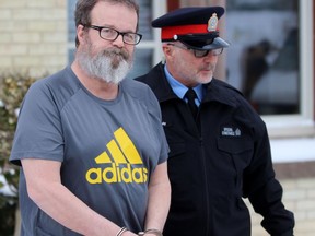 John Paul Stone, left, is escorted out of the Perth County Courthouse by Patrick Kelly, a Stratford police special constable, on Thursday December 19, 2019 in Stratford, Ont. (Terry Bridge/Stratford Beacon Herald)