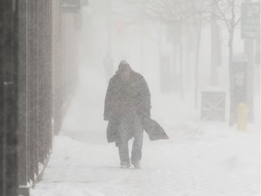 Jeff de Roux cuts a distinct figure as he trudges along during a heavy snow squall in London in this February 2014 file photo. (Mike Hensen/The London Free Press)