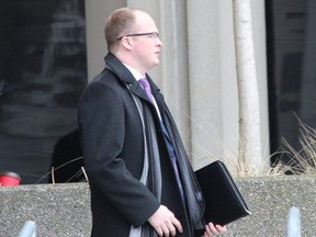 Const. Travis Buckle leaves the London courthouse during a break on the opening day of his assault causing bodily harm trial. The Special Investigations Unit charged Buckle, 26, in the arrest injury of a man at Victoria hospital on Feb. 10, 2019. (DALE CARRUTHERS, The London Free Press)