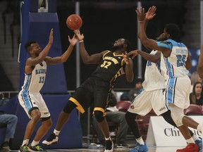 The London Lightning's Randy Phillips, centre, tries to grab a loose ball in front of Halifax Hurricanes player Joel Kindred, during National Basketball League of Canada action in Halifax on Tuesday. The Lightning won 112-101. (Tim Krochak/ The Chronicle Herald)