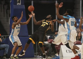 The London Lightning's Randy Phillips, centre, tries to grab a loose ball in front of Halifax Hurricanes player Joel Kindred, during National Basketball League of Canada action in Halifax on Tuesday. The Lightning won 112-101. (Tim Krochak/ The Chronicle Herald)