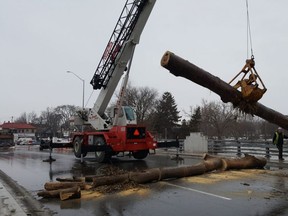 The Fifth Street bridge in downtown Chatham was closed to traffic Friday morning as crews hauled large trunks and other debris from the Thames River. (Trevor Terfloth/The Daily News)