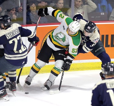 Windsor, Ontario. January 23, 2020. London Knights Markus Phillips holds off Windsor Spitfires Curtis Douglas, right, in OHL action from Windsor's WFCU Centre Thursday. (NICK BRANCACCIO/Windsor Star)