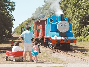 A family watches as Thomas the Tank Engine chugs along the Talbot Spur with a full load of visitors on the first weekend of Day Out With Thomas hosted by the Elgin County Railway Museum at the St. Thomas-Elgin Memorial Centre.  (Postmedia Network file photo)