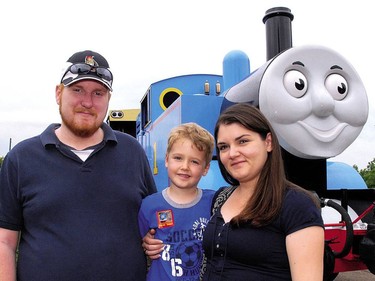James, left, Keaton and Melanie Miller from Guelph, prepare to take a ride on Thomas the Tank Engine during A Day Out With Thomas at St. Thomas-Elgin Memorial Centre. (File photo)
