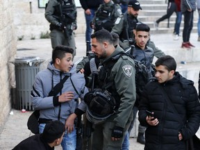 Members of Israeli security detain a Palestinian protester during a rally against a US-brokered Middle East peace plan, outside the Damascus Gate of the Old City of Jerusalem, on January 29, 2020. - Palestinians protested against the US President's controversial plan that gives Israel an American green light to annex key parts of the occupied West Bank. The protests, including isolated clashes, underscored the depth of frustration with a proposal seen as overwhelmingly supportive of Israeli objectives and drafted with no Palestinian input. (Photo by AHMAD GHARABLI / AFP)