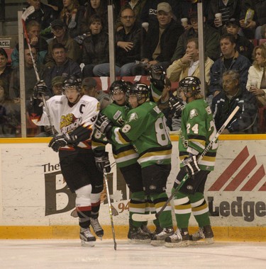 Dejected Owen Sound Attack captain Bobby Ryan turns away as London Knights forwards Adam Perry, second left, Patrick Kane and Sergei Kostitsyn celebrate a goal during Game 4 of the OHL Western Conference quarter-final last night in Owen Sound. The Knights won 8-5 to sweep the series. (James Masters/Postmedia files)