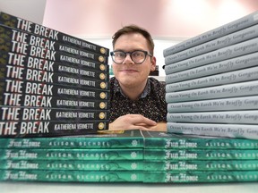 Matthew Stepanic, co-owner of the Glass Bookshop in Edmonton, shows off some of the favourite books in his book club. Photo taken Jan. 8, 2020. (Ed Kaiser/Postmedia Network)