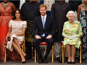 Queen Elizabeth, Prince Harry and Meghan, the Duchess of Sussex, pose for a picture in London, June 26, 2018. (John Stillwell/Pool via Reuters/File Photo)