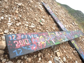 A cross at a mass grave north of Port-au-Prince bears the date of Haiti's deadly earthquake. (ELLIOT FERGUSON, Postmedia Network)