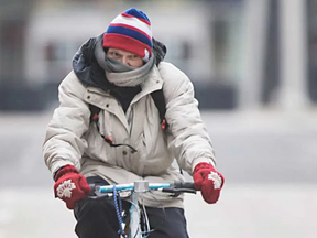 His mittens read 'Canada' -- as if his location was ever in doubt. This Windsor cyclist bundled up to ride through the deep freeze that has gripped Southwestern Ontario this week. Photo taken Jan 16, 2020. (Dax Melmer/The Windsor Star)