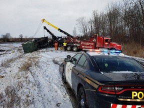 A photo from the scene on the westbound Highway 402 between Mt. Brydges and Glendon Drive, where two trucks hauling garbage have overturned.  Motorists should consider using Longwoods Road as a detour until the scene is cleared. (OPP Twitter)