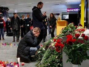 Relatives of the flight crew members of the Ukraine International Airlines Boeing 737-800 plane that crashed in Iran, mourn at a memorial at the Boryspil International airport outside Kiev, Ukraine January 8, 2020. (REUTERS/Valentyn Ogirenko)