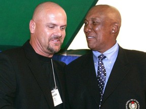 Larry Walker, left, receives congratulations from Fergie Jenkins upon his induction into the Canadian Baseball Hall of Fame in St. Marys, Ont., on June 20, 2009. (File Photo)