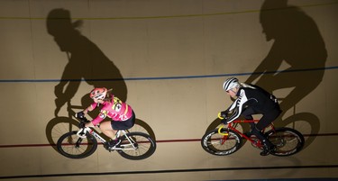 John Hueston trails Sue Gazda while riding along the 138-metre track at the Forest City Velodrome in London on Sunday. Hueston estimates that he's put in 50,000 kilometres over his 15 years as a Velodrome member. Derek Ruttan/The London Free Press/Postmedia Network