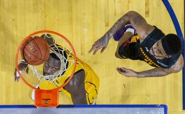 The London Lightning's Randy Phillips watches his shot sink through the net while covered by Sudbury Five player Josiah Moore during their basketball game at the Budweiser Gardens in London, Ont. on Sunday January 5, 2020. Derek Ruttan/The London Free Press/Postmedia Network