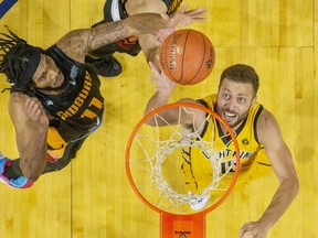 The London Lightning's Garrett Williamson tips in a rebound while covered by Sudbury Five players Marlon Johnson (left) and Malcolm Duvivier during their basketball game at Budweiser Gardens in London on Sunday January 5, 2020. Derek Ruttan/The London Free Press/Postmedia Network