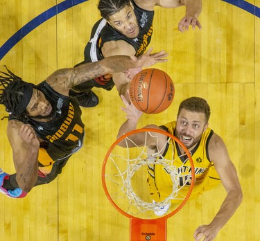 The London Lightning's Garrett Williamson tips in a rebound while covered by Sudbury Five players Marlon Johnson (left) Malcolm Duvivier during their basketball game at the Budweiser Gardens in London, Ont. on Sunday January 5, 2020. Derek Ruttan/The London Free Press/Postmedia Network