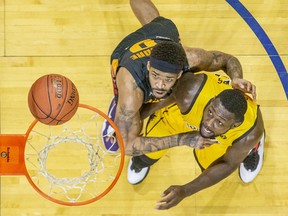 Sudbury Five player Josiah Moore (left) and London Lightning's Randy Phillips jockey for position to grab a rebound during their basketball game at Budweiser Gardens in London on Sunday January 5, 2020. Derek Ruttan/The London Free Press/Postmedia Network