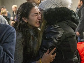 People mourn at a memorial  service at Western University in London, Ont. on Wednesday Jan. 8, 2020 for four Western students killed in the crash of Ukraine International Airline flight PS752 in Iran. Derek Ruttan/The London Free Press