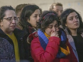 People mourn at a memorial  service at Western University in London, Ont. on Wednesday Jan. 8, 2020 for four Western students killed in the crash of Ukraine International Airline flight PS752 in Iran. Derek Ruttan/The London Free Press