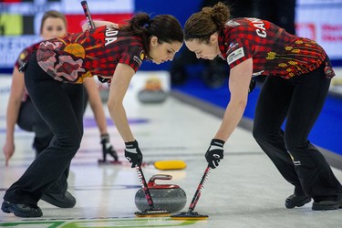 Team Canada's Lisa Weagle, left, and Joanne Courtney sweep the ice in front of a rock thrown by Emma Miskew during the opening round of the Continental Cup against Team Europe at the Western Fair Sports Centre in London, Ont. on Thursday Jan. 9, 2020. The Canadian's won the contest 6-5. Derek Ruttan/The London Free Press