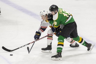 London Knight Liam Foudy duels with Barrie Colt Luke Bignell during their game at Budweiser Gardens in London, Ont. on Saturday January 11, 2020. Derek Ruttan/The London Free Press/Postmedia Network