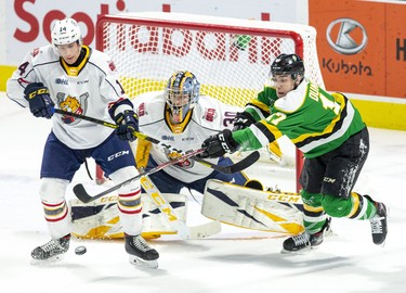London Knight Nathan Dunkley tries to tip the puck past Barrie Colts defender Ian Lemieux and goalie Arturs Silvo during their game at Budweiser Gardens in London, Ont. on Saturday January 11, 2020. Derek Ruttan/The London Free Press/Postmedia Network
