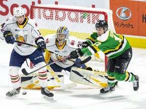 London Knight Nathan Dunkley tries to tip the puck past Barrie Colts defender Ian Lemieux and goalie Arturs Silovs during their game at Budweiser Gardens in London, Ont. on Friday January 10, 2020. Derek Ruttan/The London Free Press/Postmedia Network