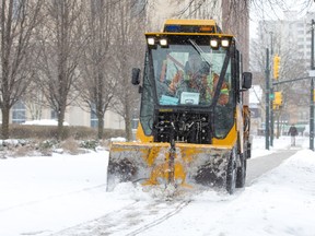 Shaun Trudell operates a sidewalk snow plow on Dufferin Avenue in London, Ont. on Sunday January 19, 2020. Trudell was nearing the end of a 12-hour shift that began at 1:00 a.m. Sunday morning. The season's first big storm brought 20 centimetres or more of snow to London and region, causing hazardous walking and driving conditions. Derek Ruttan/The London Free Press/Postmedia Network