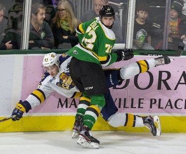 Emmett Sproule of the Erie Otters is pasted to the boards by London Knights defenseman Alec Regula during the third period of their game at Budweiser Gardens in London, Ont. on Sunday January 19, 2020. Derek Ruttan/The London Free Press/Postmedia Network