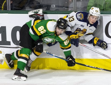 Emmett Sproule of the Erie Otters is pinned agains the boards by Jason Willms of the London Knights during the third period of their game at Budweiser Gardens in London, Ont. on Sunday January 19, 2020. Derek Ruttan/The London Free Press/Postmedia Network