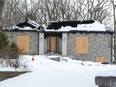 Habiba Kajan has been ordered to make safe her Commissioners Road property, shown her Tuesday, after a suspected arson gutted the house last month. (Derek Ruttan/The London Free Press)