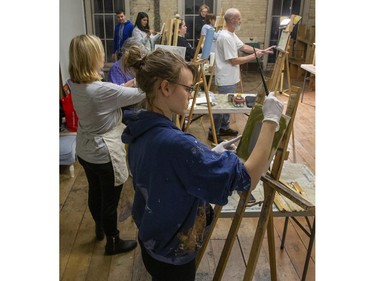 Oil painting students stroke their canvasses during a class taught by artist Paul Abeleira at the TAP Centre For Creativity in London on Thursday January 23, 2020. To take part in one of the many different art classes offered by TAP check their out website www.tapcreativity.org. Foreground to back are Kirsten Von Holtzendorff, Jan Collins, David Bratton, Martin Wall, Regina Arcia Martinez, Harmeet Dhindsa, Paul Abeleira, Wendy Hill and Deb Pullen. (Derek Ruttan/The London Free Press)