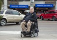 Peter Zein  says the parking setup at  London hospitals (gates, tickets, automated payment machines) are a major barrier for quadriplegics like him. (Derek Ruttan/The London Free Press)