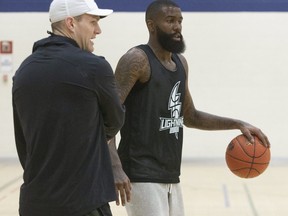 The London Lightning's newest player Terry Thomas speaks with head coach Doug Plumb during team practice at the YMCA in downtown London, Ont. (Derek Ruttan/The London Free Press)