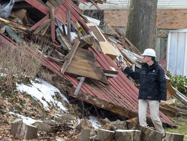 City of London building inspector Mike Romashyna gathers information after a historic barn in London's west-end Byron neighbourhood was torn down Thursday night, mere days after city council gave it heritage protection. (Derek Ruttan/The London Free Press)