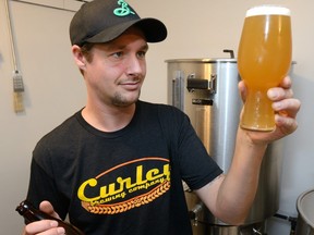 Nigel Curley holds a sample of his Hoprunner IPA beer at the Curley Brewing Company on Monday November 6, 2017.  (Free Press file photo)