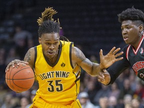 AJ Gaines Jr. of the London Lightning drives around Windsor's Shaquille Keith during the first half of their NBL game Thursday night at Budweiser Gardens in London. Mike Hensen/The London Free Press/Postmedia Network