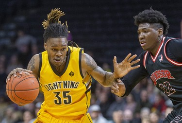 AJ Gaines Jr. of the London Lightning drives around Windsor's Shaquille Keith during the first half of their NBL game Thursday night at Budweiser Gardens in London. Mike Hensen/The London Free Press/Postmedia Network