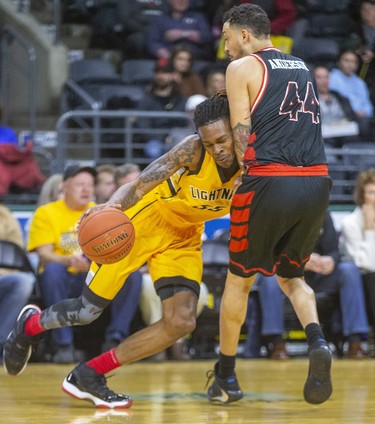 AJ Gaines of the London Lightning runs into Ryan Anderson of the Windsor Express, who picked up a blocking foul, during the first half of their NBL game Thursday night at Budweiser Gardens in London. Mike Hensen/The London Free Press/Postmedia Network