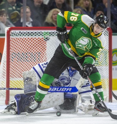 Billy Moskal tries to dig the puck out from his skates in front of Mississauga goalie Kai Edmonds during the first period of their game Friday night at Budweiser Gardens in London, Ont. 
Photograph taken on Friday January 3, 2020. 
Mike Hensen/The London Free Press/Postmedia Network