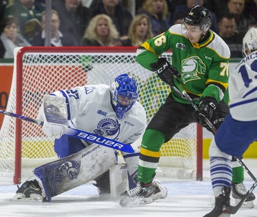 Billy Moskal tries to dig the puck out from his skates in front of Mississauga goalie Kai Edmonds during the first period of their game Friday night at Budweiser Gardens in London, Ont. 
Photograph taken on Friday January 3, 2020. 
Mike Hensen/The London Free Press/Postmedia Network