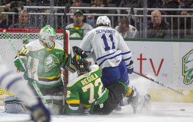 Knights captain Alec Regula comes back to take out Cole Schwindt of Mississauga at the side of the net, being guarded by Brett Brochu during the first period of their game Friday night at Budweiser Gardens in London, Ont. 
Photograph taken on Friday January 3, 2020. 
Mike Hensen/The London Free Press/Postmedia Network