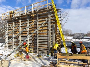 Hayman Construction workers are working on what will become the easternmost bridge across the north branch of the Thames River in London. Photograph taken on Wednesday January 8, 2020.  (Mike Hensen/The London Free Press)