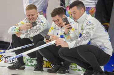 Waiting their turn to test the ice at the Western Fair Sports Centre on Wednesday, Bobby Lammie, Grant Hardie and Hamilton (Hammy) McMillan from Glascow, Scotland, enjoy their phones. The European players took to the rinks for their first practice for the Continental Cup, which starts Thursday in London. (Mike Hensen/The London Free Press)