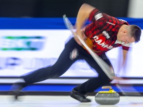 Ben Hebert sweeps his own rock during the mixed doubles competition at the Continental Cup at the Western Fair Sports Centre in London Saturday. Hebert and partner Rachel Homan of Team Canada fell behind 7-0 after two ends to Europe's mixed doubles duo of Eve Muirhead and Bobbie Lammie. The match ended after 7 ends with Europe winning 10-2.