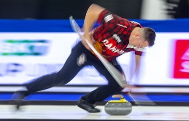 Ben Hebert sweeps his own rock during the mixed doubles competition at the Continental Cup at the Western Fair Sports Centre in London Saturday. Hebert and partner Rachel Homan of Team Canada fell behind 7-0 after two ends to Europe's mixed doubles duo of Eve Muirhead and Bobbie Lammie. The match ended after 7 ends with Europe winning 10-2.